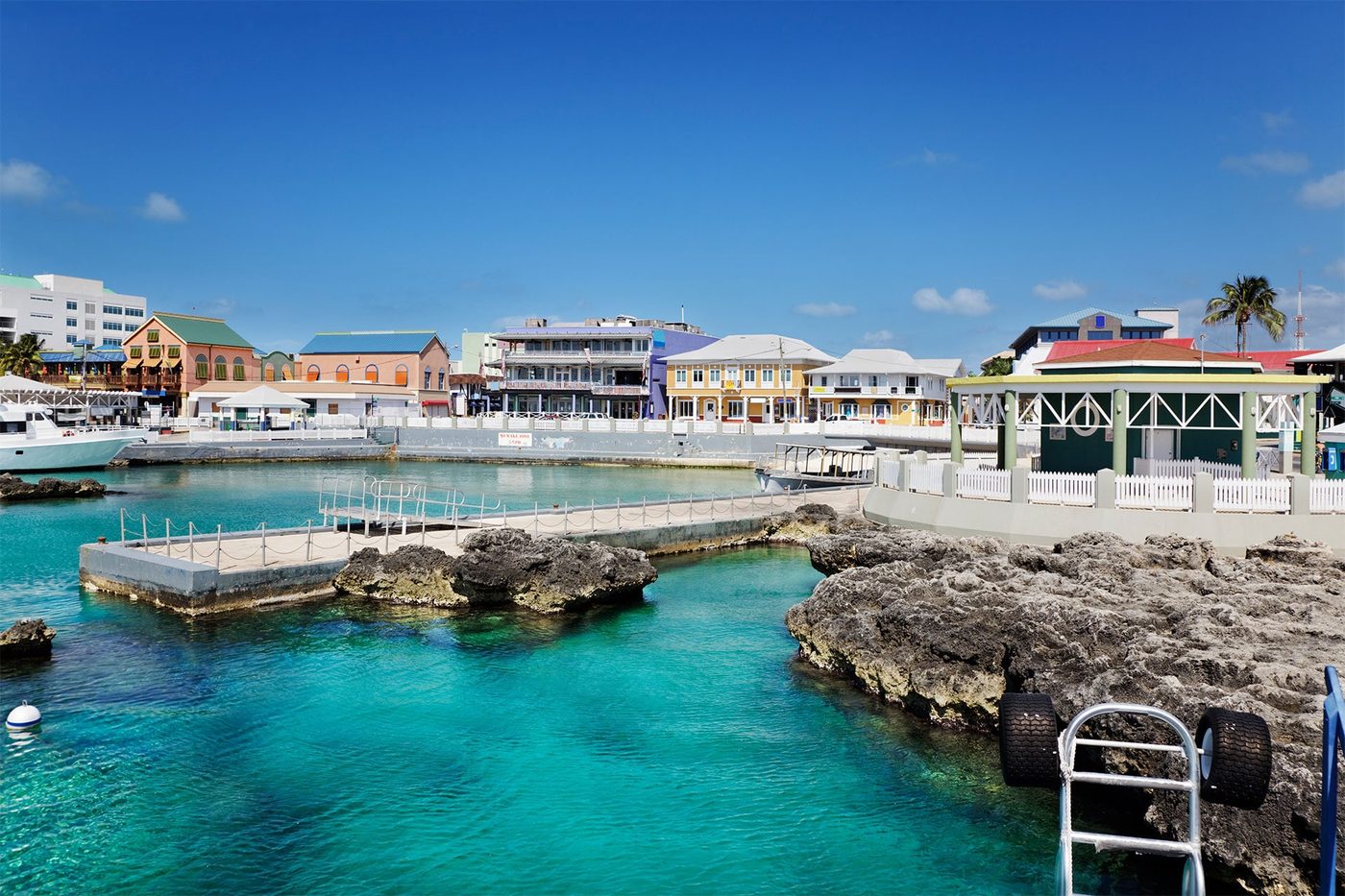 The Cayside Galleries waterfront buildings on Harbour Drive, George Town, seen across the turquoise water of the harbour
